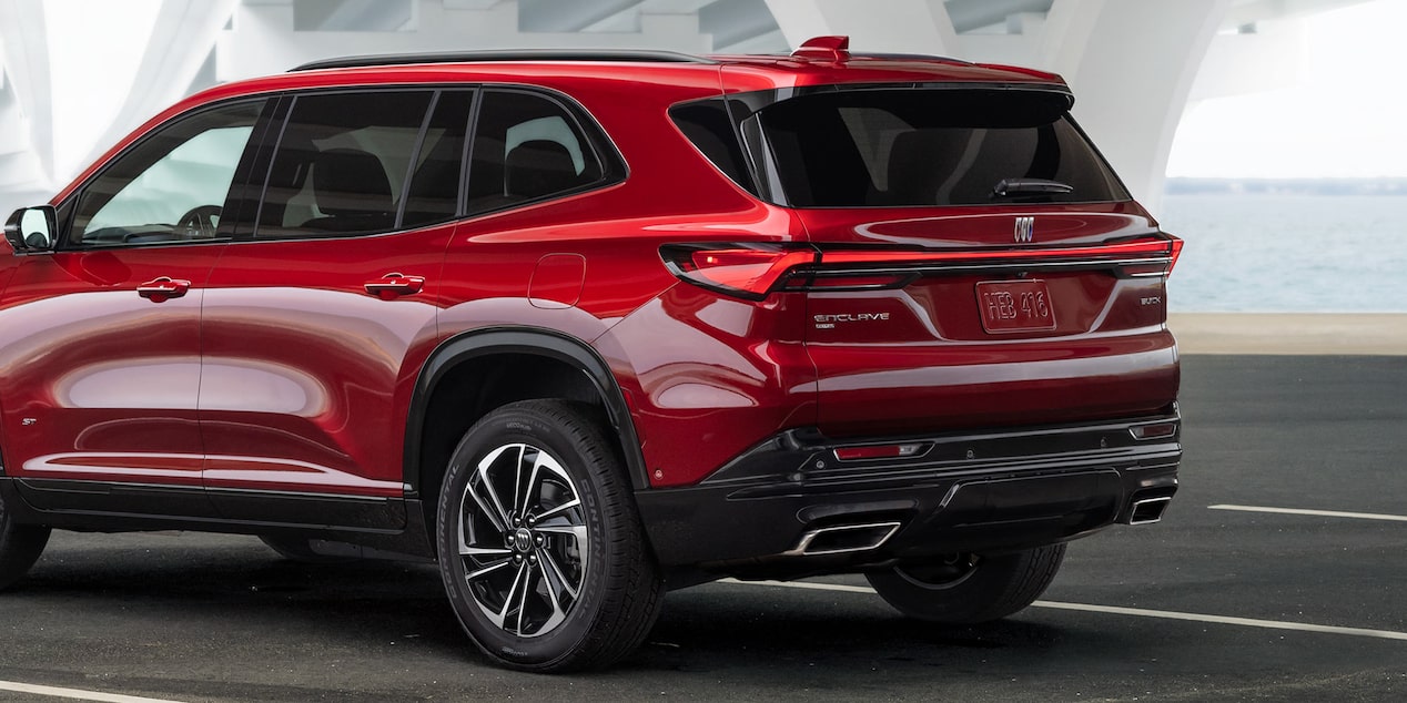 Back-side view of the 2025 Buick Enclave ST driving under a shade.