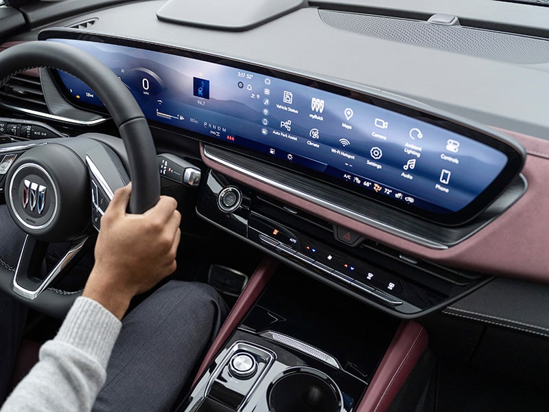 A driver holding the steering wheel inside the 2025 Buick Envision Compact SUV.