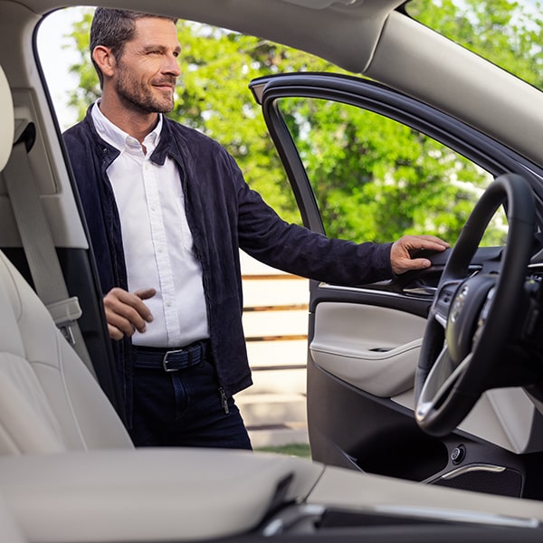 Opening the front door of the 2024 Buick Enclave.