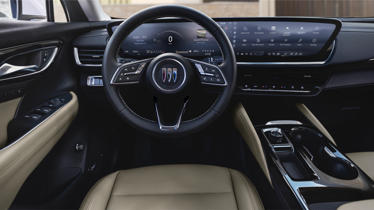 2024 Buick Envision front interior featuring the steering wheel and infotainment system.