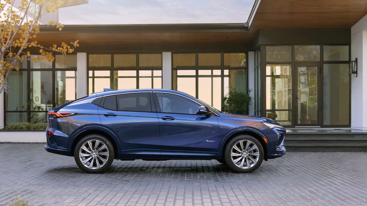 Right side view of the 2024 Buick Envista Avenir parked outside a home.