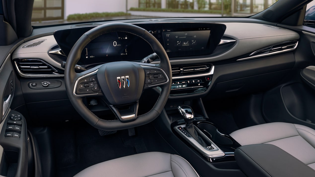 2024 Buick Envista Avenir front interior featuring the Tri-Shield Badge on the steering wheel.