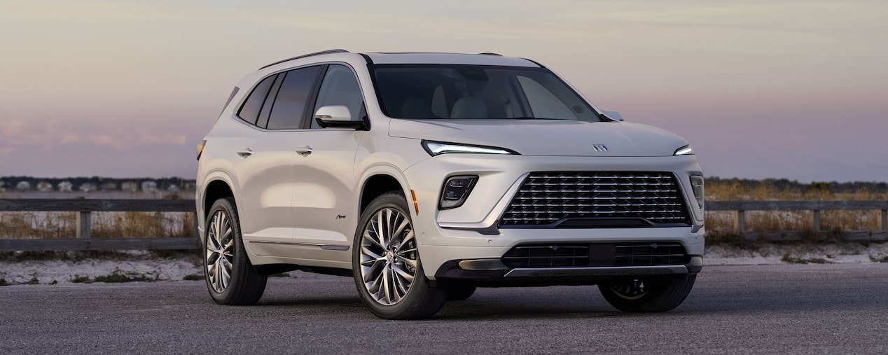 Front-side view of the 2025 Buick Enclave parked outdoors during sunset.