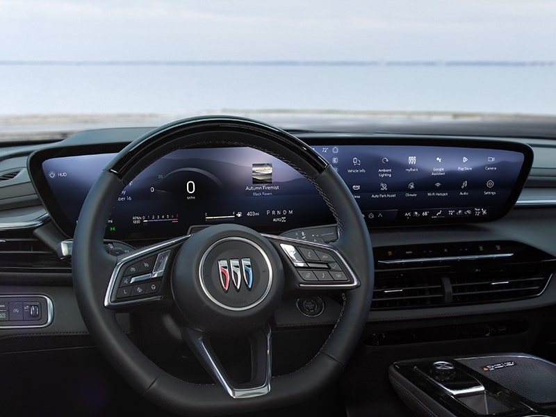 Driver's view of the steering wheel and infotainment screen on the 2025 Buick Enclave.