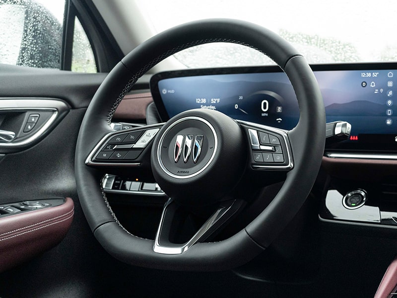 Close-up View of the Steering Wheel and Dashboard in a 2025 Buick Envision ST Sporty Compact SUV.