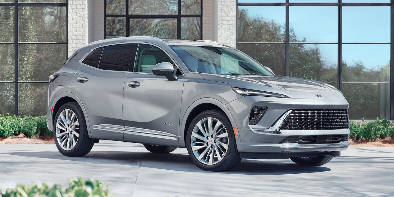 Front-side View of a 2025 Buick Envision Compact SUV Parked outside a building.