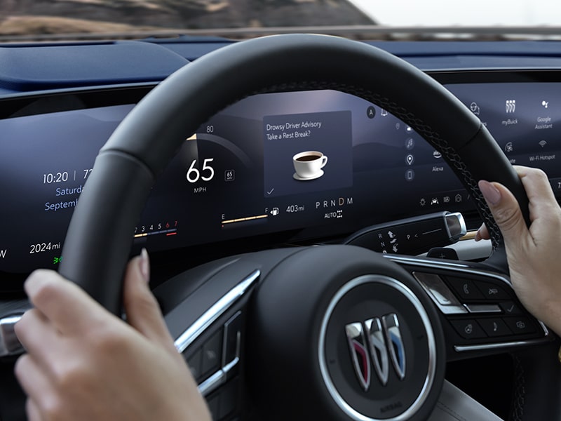 Close-up View of a Person's Hands on a Steering Wheel on the 2025 Buick Envision Compact SUV.