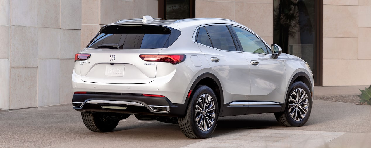 Rear view of a 2025 Buick Envision Compact SUV Parked Near a Building.