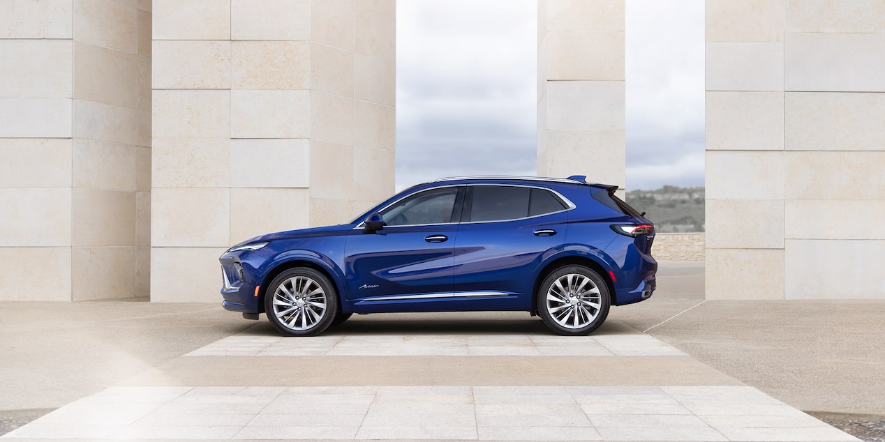 Side View of a 2025 Buick Envision Compact SUV parked near white columns.