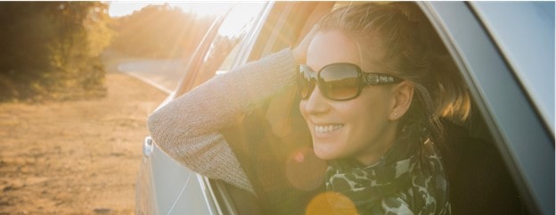 A woman in a car that works for a company eligible for GM's Preferred Pricing Program.