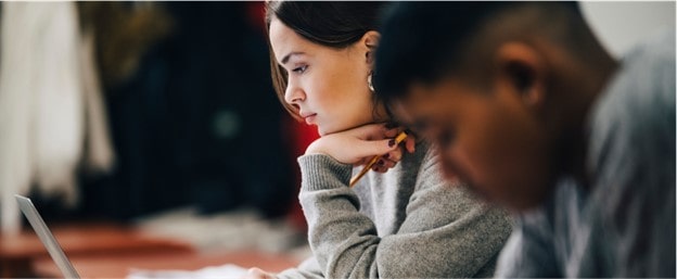 Two students studying for a test  eligible for GM's Student Bonus Program.